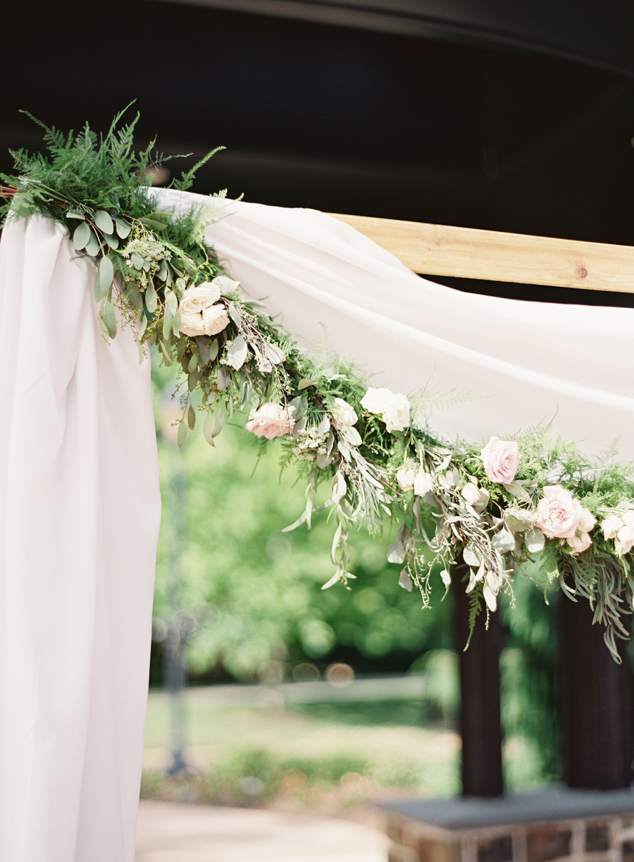 foliage and flowers on ceremony backdrop
