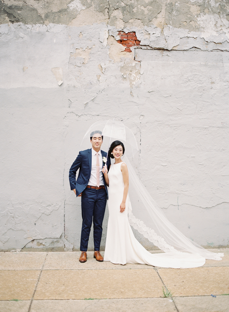 bride and groom with clear umbrella in Fishtown