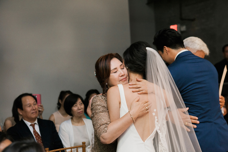 mom hugging bride during ceremony
