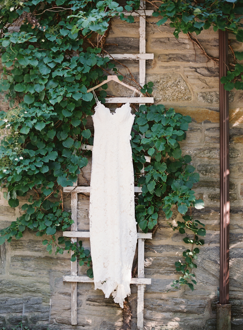 BHLD dress hanging on trellis with ivy, Morris Arboretum Wedding