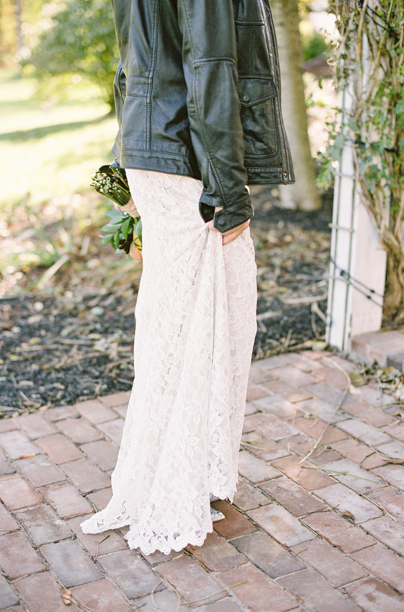 close up of BHLDN lace dress with black leather jacket, film image